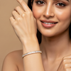 Woman wearing a silver bracelet on a beige background